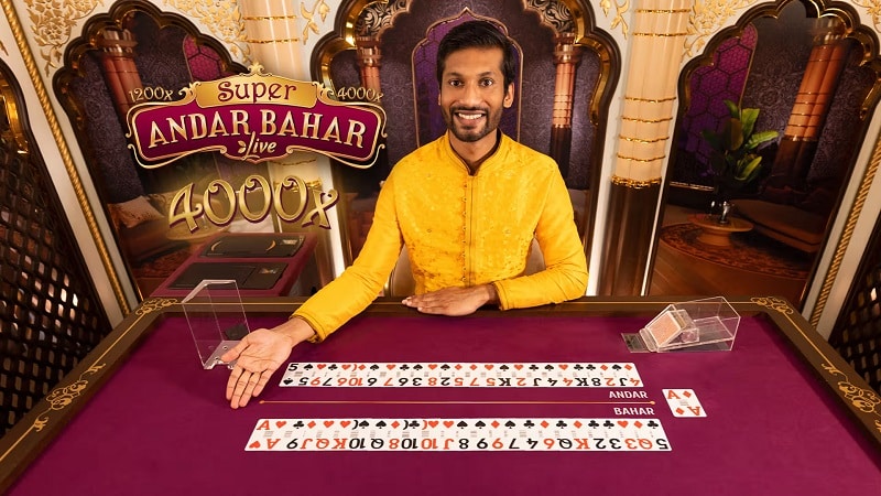 Live dealer at a Super Andar Bahar table with two rows of cards laid out in front of him